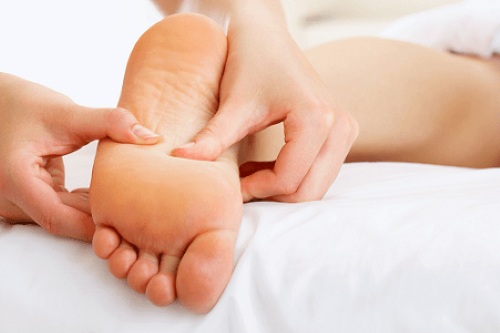 Therapist performing foot reflexology massage