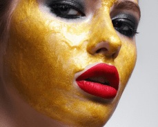 Woman with 24K gold facial mask