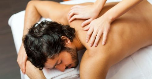 Man getting a massage in his private villa