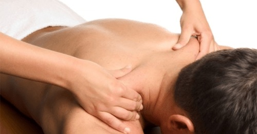 Massage therapist working on man's back